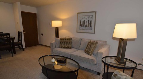A living room with a couch, two lamps, and a coffee table.