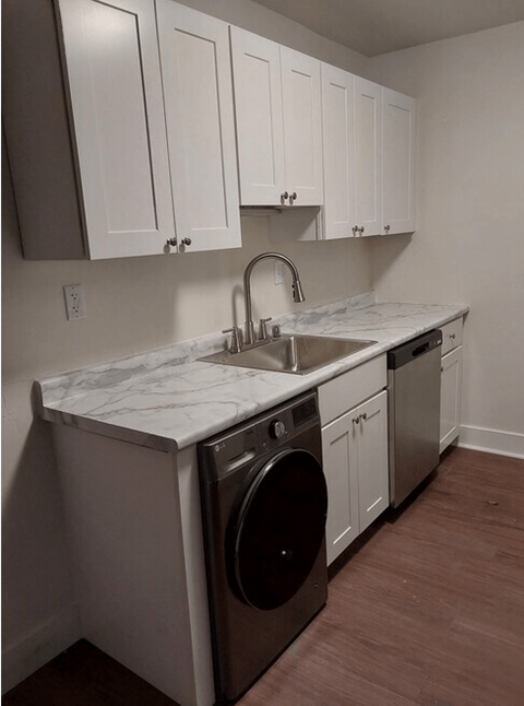 A small laundry room with a washer and dryer.