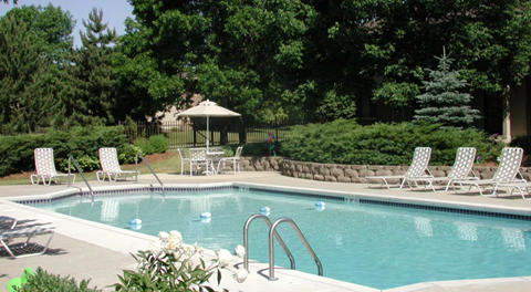 A pool with a gazebo in the background.