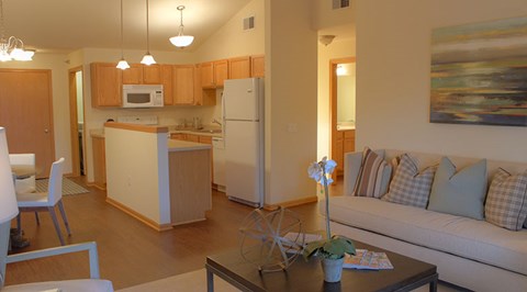 A modern kitchen with a dining table and chairs.
