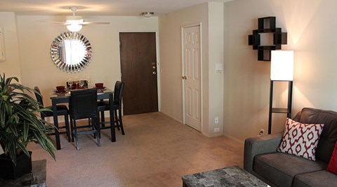 A living room with a grey couch and a black table.