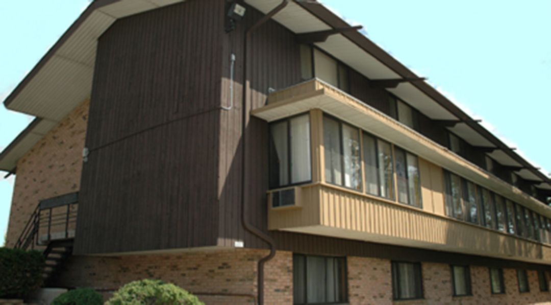 A building with a balcony and a staircase.