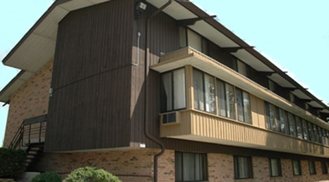 A building with a balcony and a staircase.