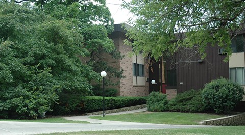 A building with a green lawn in front.