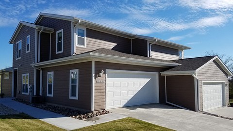 A two-story house with a garage on the right side.