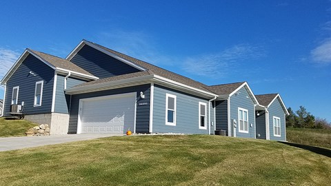 A blue house with a garage door that says "CLOSED".