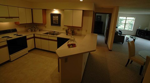A kitchen with a table and chairs in the middle of the room.