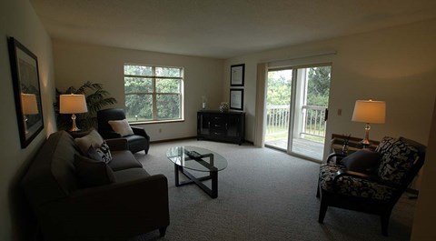 A living room with a couch, chair, and lamp.
