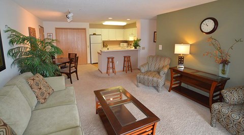A living room with a couch, chair, and coffee table.