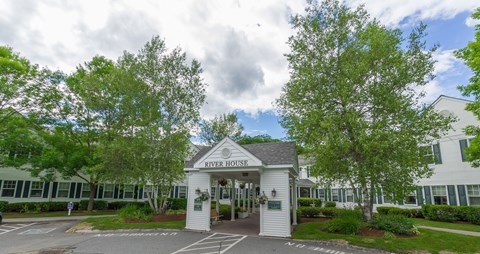 A white building with a sign that says River House.