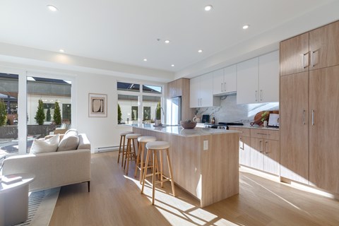 A modern kitchen with wooden cabinets and a large island.