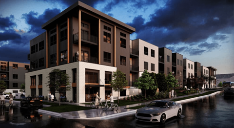 A row of modern apartment buildings with cars parked in front.