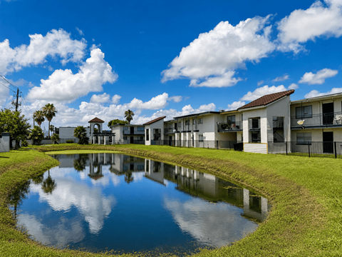 A pond in front of the apartment building located at the pointe apartments in Pasadena, Tx