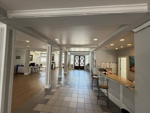 A long hallway with a kitchen area on the right.