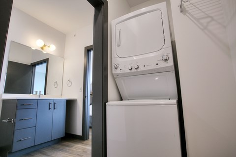 A white oven in a kitchen with a grey cabinet.