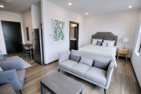 Studio with bed sofa and refrigerator at The Traveler Apartments, Nebraska