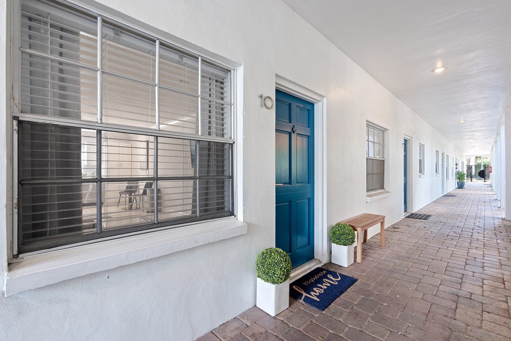 a white house with a blue door and window