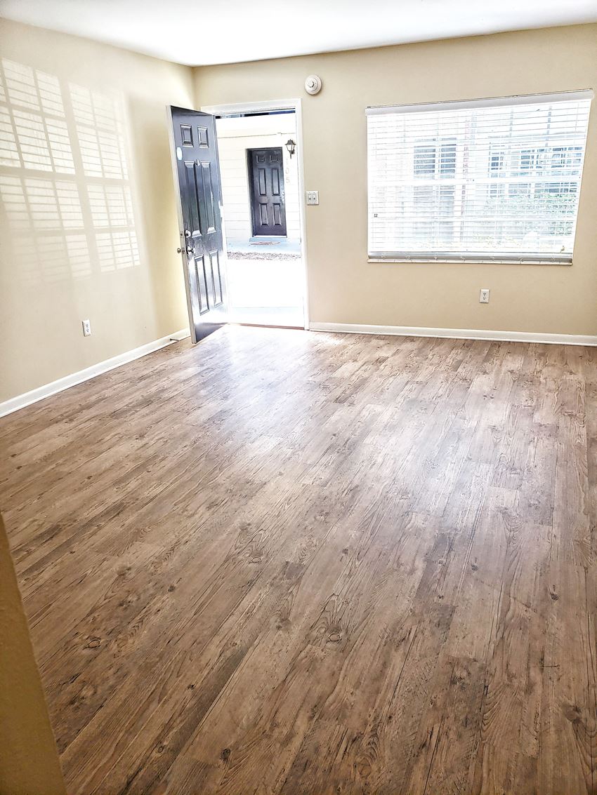 an empty room with a hardwood floor - Photo Gallery