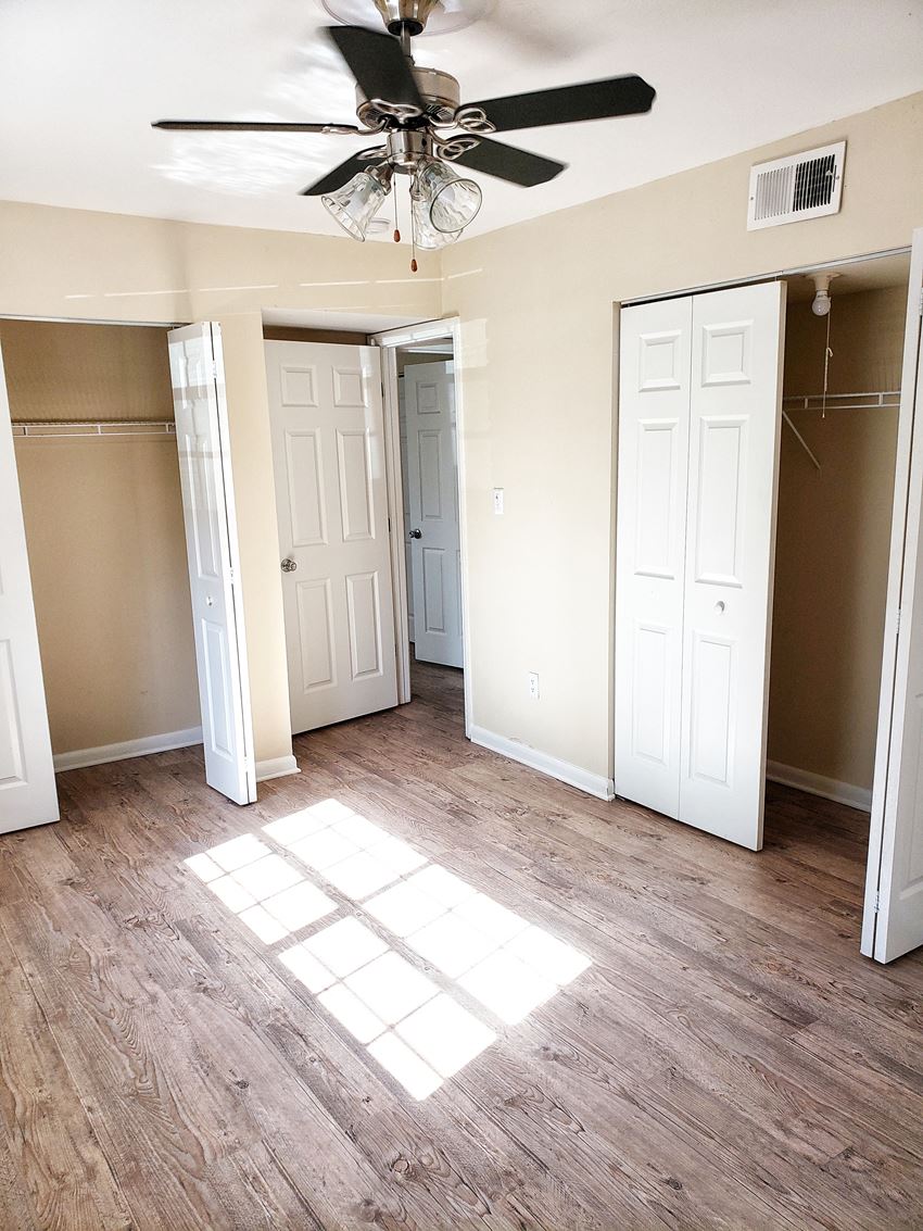 an empty bedroom with a ceiling fan - Photo Gallery