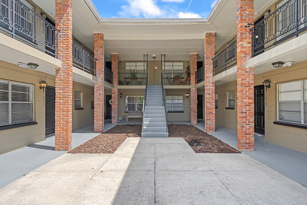 a stairway leading up to an apartment building