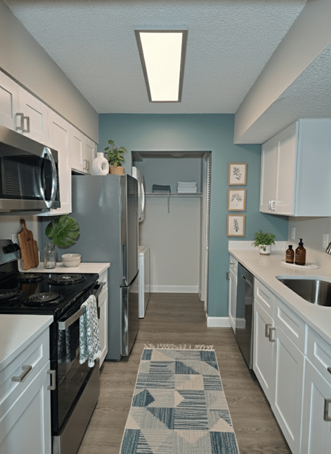 A kitchen with a black stove top oven and a black microwave.