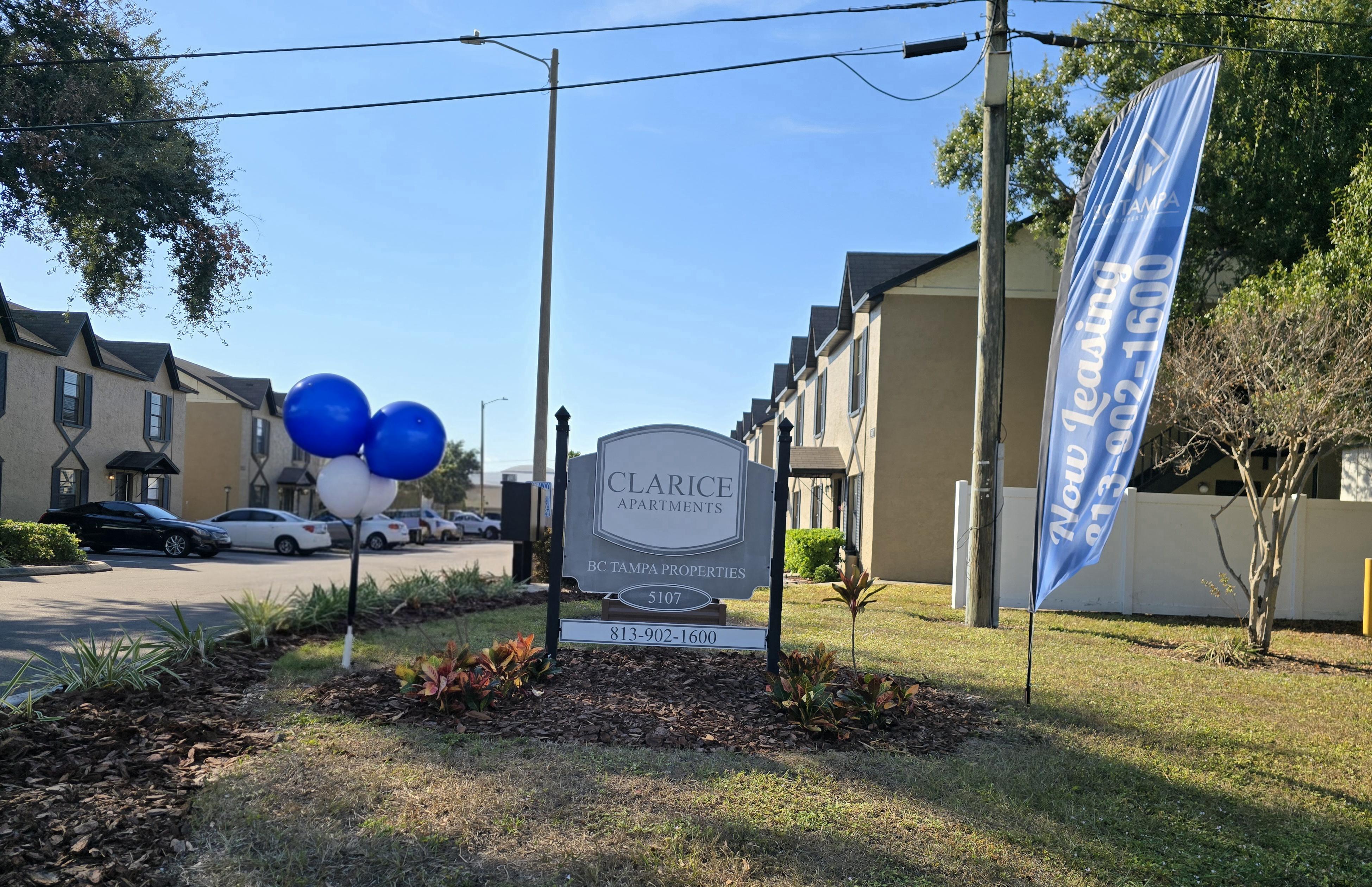 A Clarice Apartments sign is in front of a building.