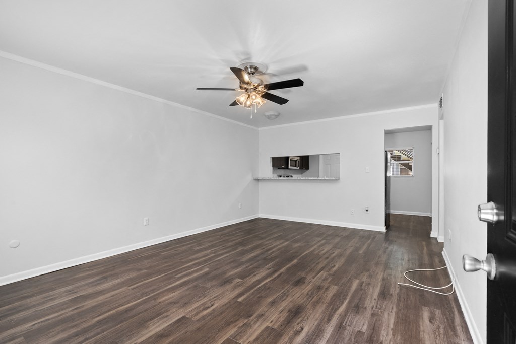 a living room with hardwood floors and a ceiling fan