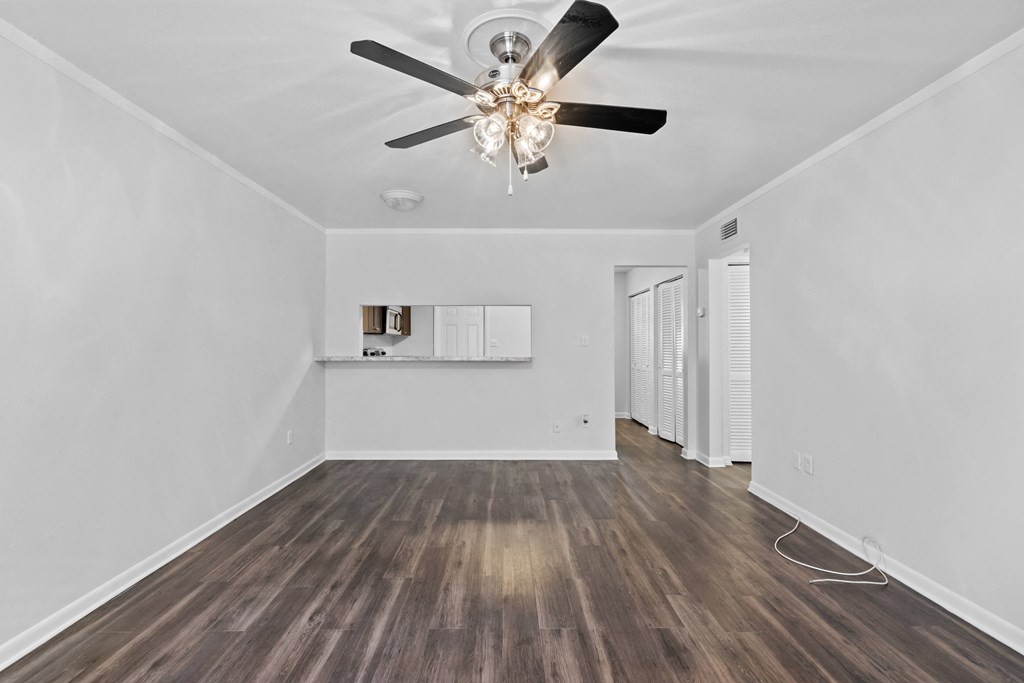 a living room with hardwood floors and white walls