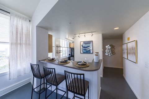 a kitchen and dining room with a table and chairs