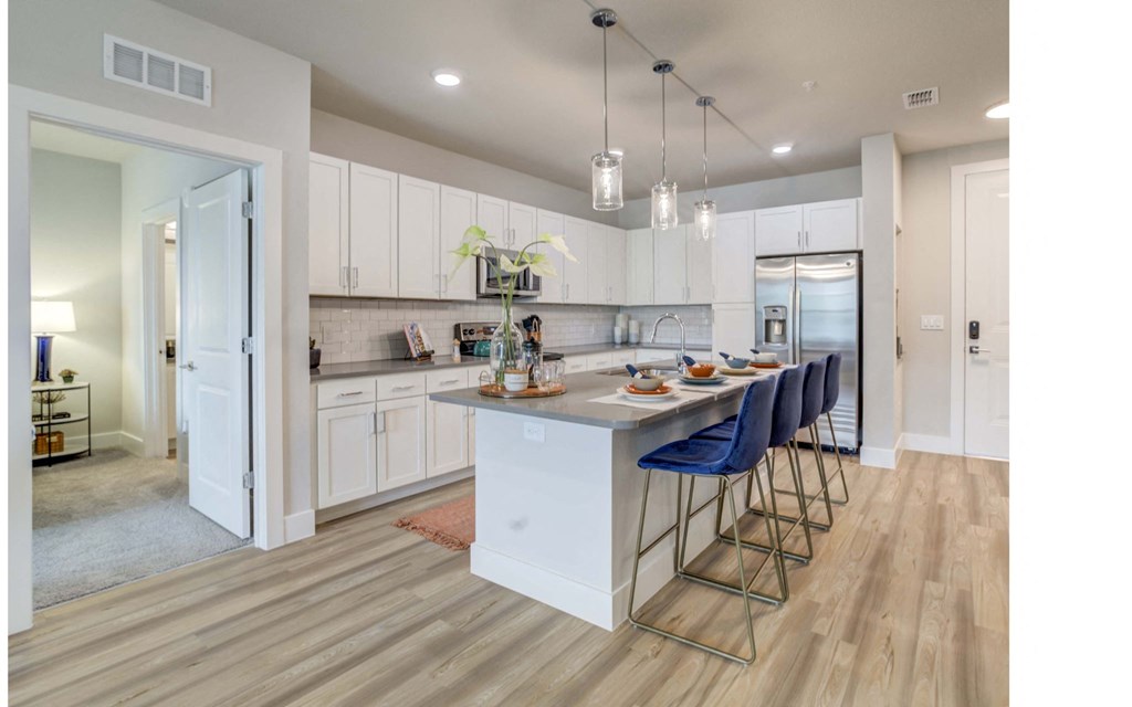 Kitchen with an island featuring blue bar stools in St. Johns, FL
