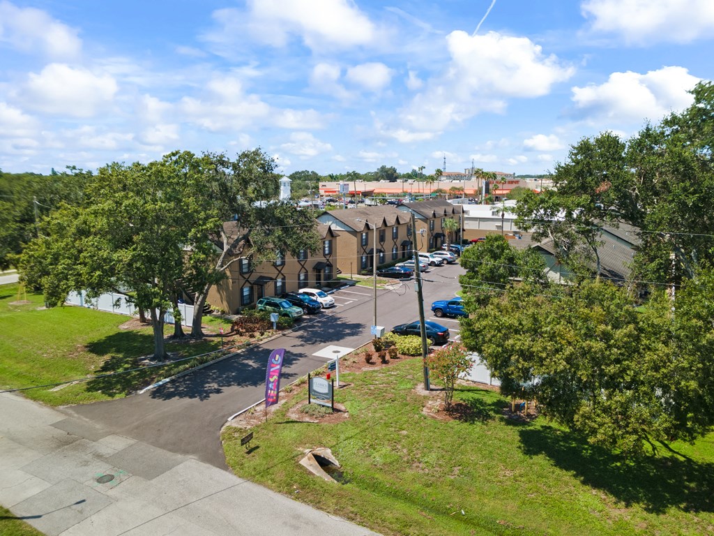 a view of a street with houses and a grassy area in front of it