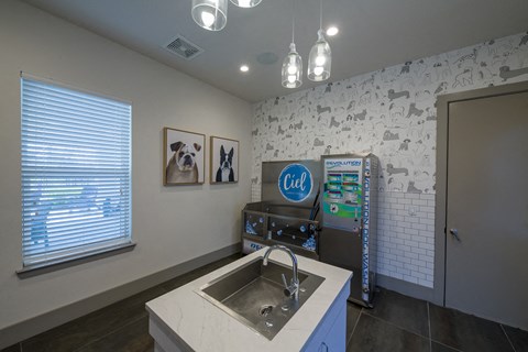 a kitchen with a sink and a refrigerator and a soda machine