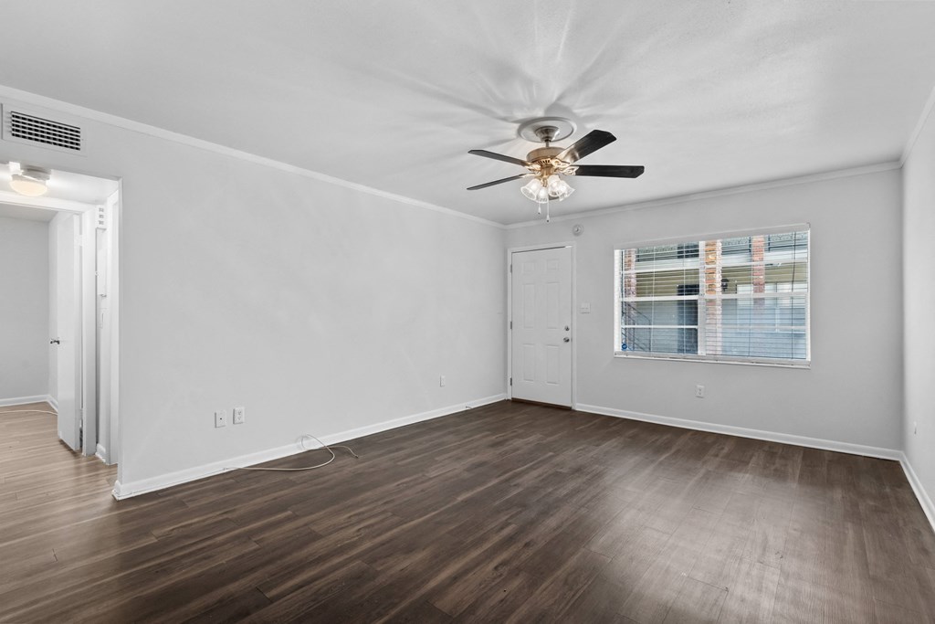 a bedroom with hardwood floors and a ceiling fan