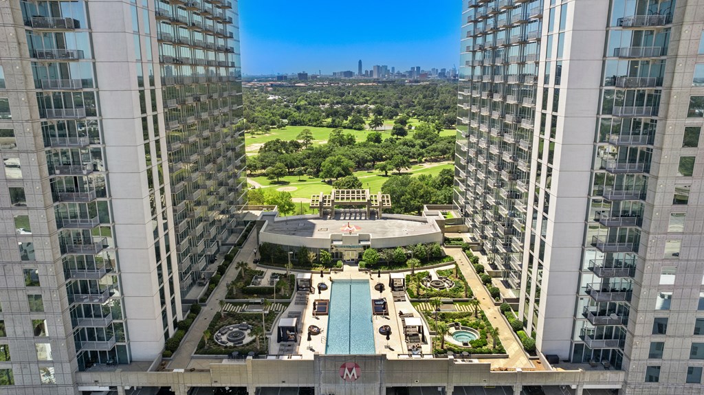 Scenic view from skyscraper top, overlooking pool and city skyline in Houston, TX
