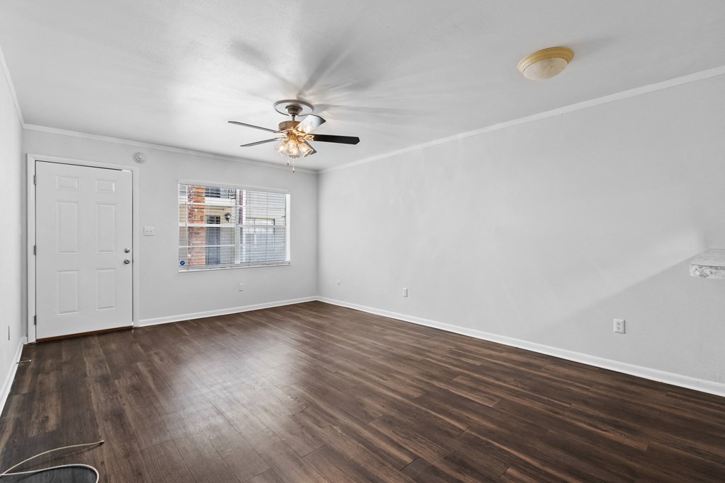 a bedroom with hardwood floors and a ceiling fan