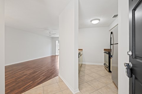 A kitchen with a black door is visible.