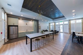 a large kitchen and dining room with a long table and chairs