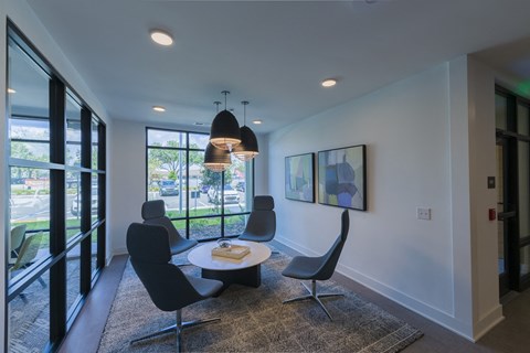 a dining room with a table and chairs and a large window