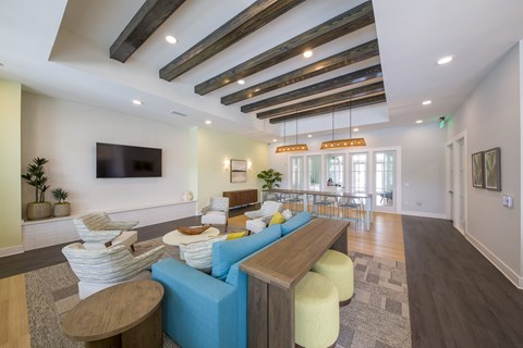 A modern living room with a blue couch and a wooden table.