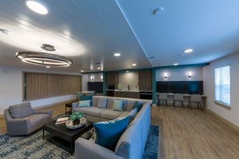 A living room with a grey couch and a coffee table.