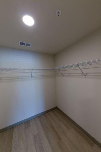 Empty room with a shelf and a light on the ceiling.