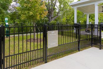 A black fence with a sign on it.