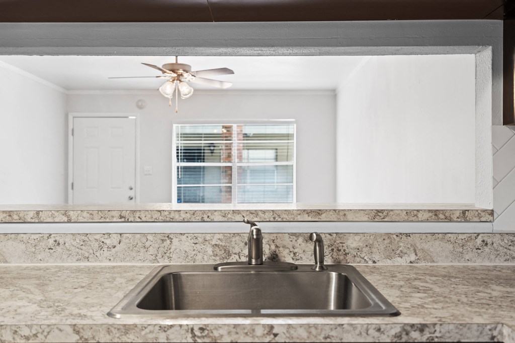 a kitchen with granite countertops and a sink