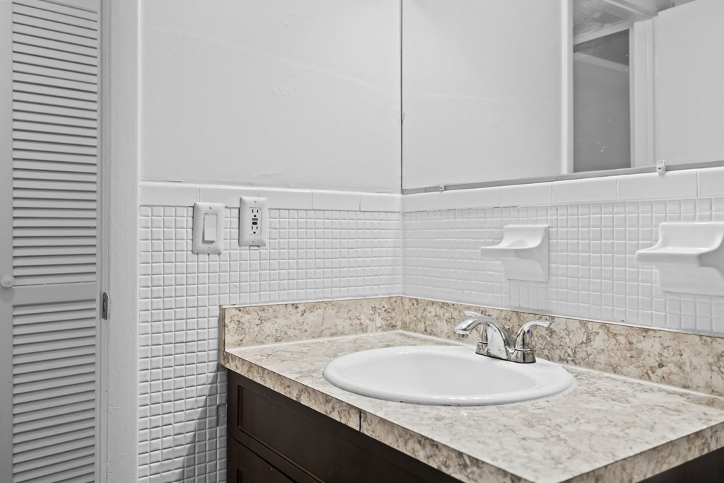 a bathroom with a sink and mirror
