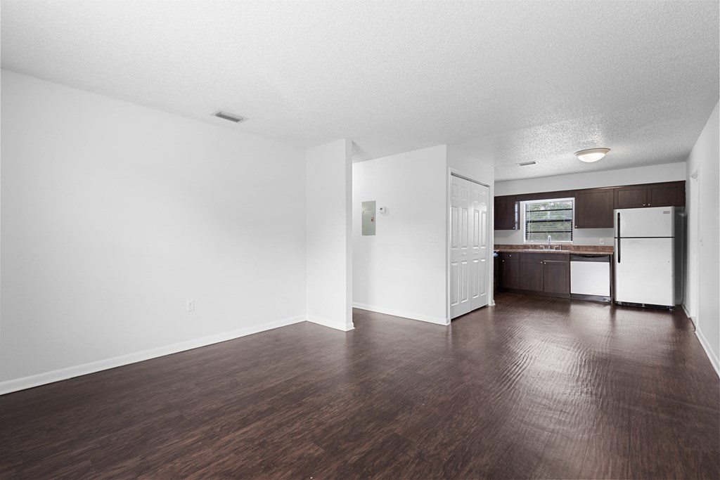a bedroom with a medium hardwood floor and white walls