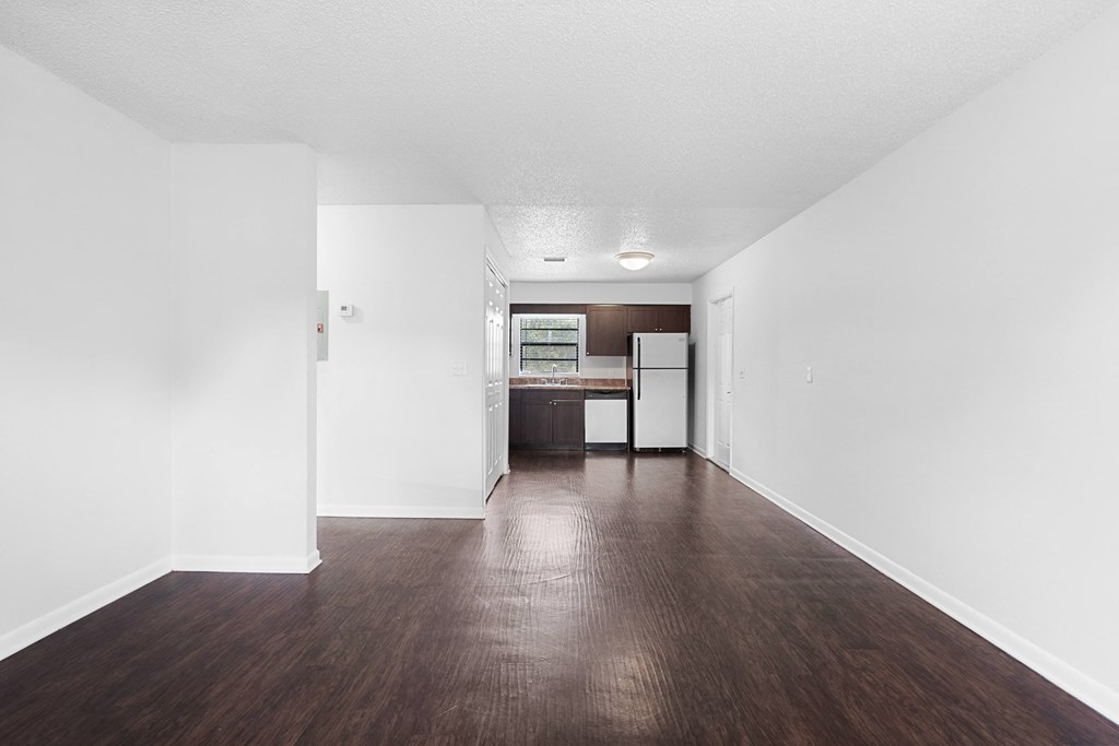 a bedroom with a medium hardwood floor and white walls