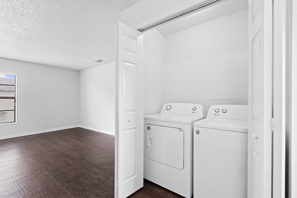 a bedroom with a washer and dryer