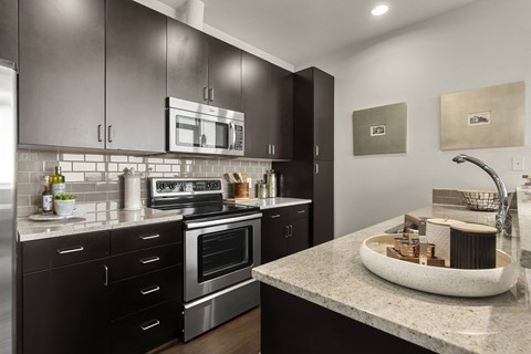 a kitchen with stainless steel appliances and granite counter tops