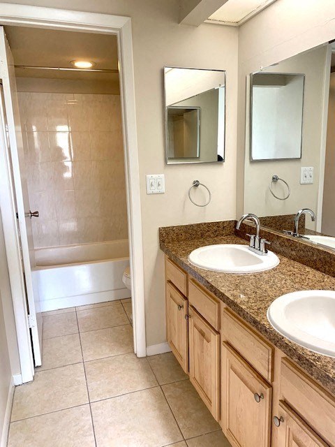 a bathroom with two sinks and a shower
