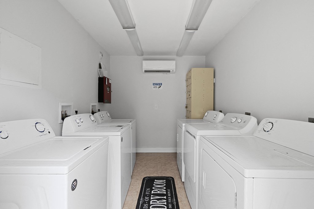a room filled with white washers and dryers